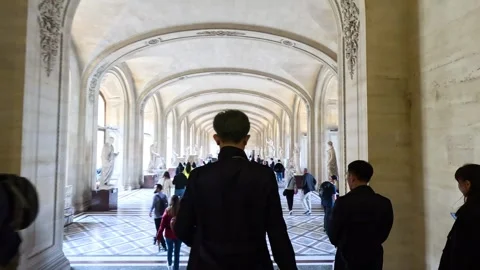 Visitors Walking Through Louvre Museum Hallway Stock Footage 298494944