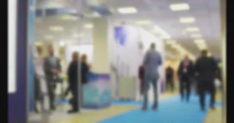 Visitors walking through a trade show corridor Stock Footage 303046432