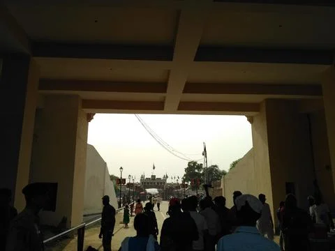 Visitors walking towards the compound for flag lowering ceremony Фото