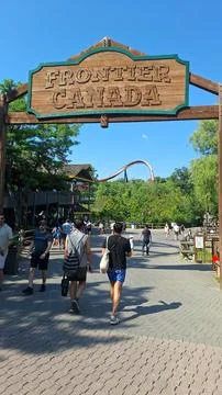 Visitors walking under the Frontier Canada entrance sign Stock Photos