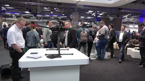 Visitors watching drones by DJI company on exhibition Cebit 2017 in Hannover Stock Footage 74108682
