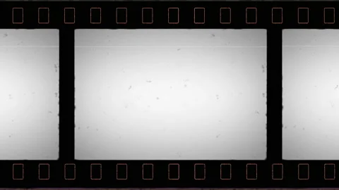 Film Reel Moves Horizontally with Empty Frame in the Middle. Stock