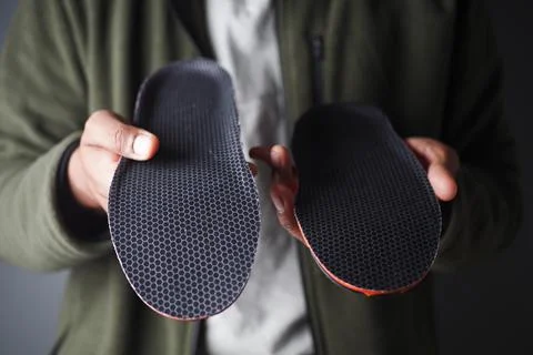 Visual comparison of two shoe insoles showcasing design and texture differences Stock Photos