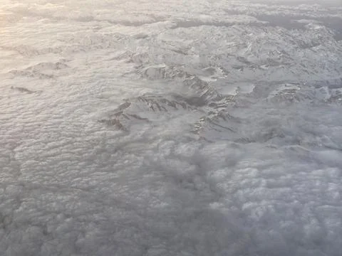 Visual depiction of textured cloud layers across icy mountain landscapes wi.. Фото
