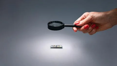 Visual of financial audit using magnifying glass to check expenses and income Stock Photos