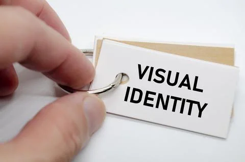 Visual identity concept presented on white notepad with hand holding it in .. Stock Photos
