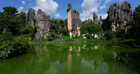 Visual illusion of rock resembling young woman figure at Shilin Stone Forest Stock Footage 329496031