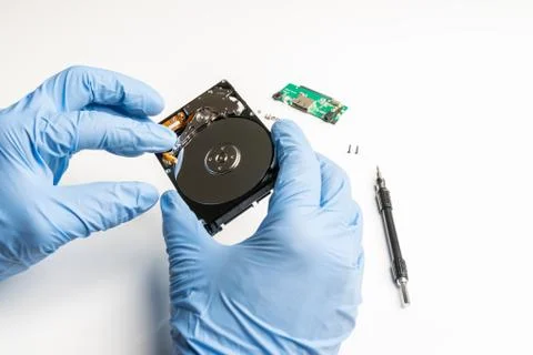 Visual inspection of an opened hard disk Stock Photos