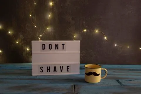 Visual Lightbox with the words dont shave and a cup with mustache on backgrou Stock Photos