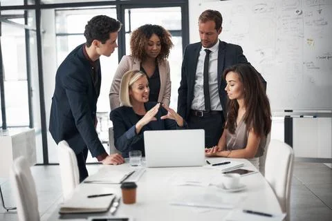 Visualise it as this...a group of businesspeople using a laptop during a meeting Stock Photos