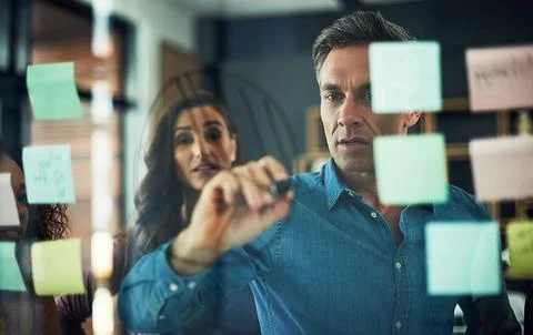 Visualising big and bold ideas. a group of businesspeople brainstorming with Foto stock