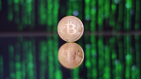 Visualization Of Mining Bitcoin. Single Bitcoin On A Mirroring Ground With Video stock 138541985