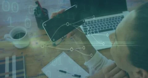 Visualizing data on phone, analyst working at office with laptop notepad pen Foto stock