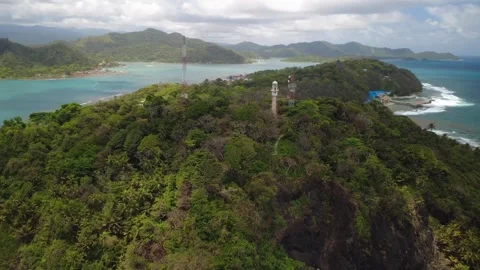 A visually appealing Caribbean island destination with an old lighthouse and sea Stock Footage 331255192