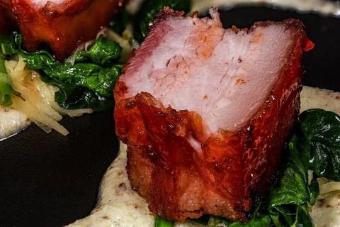 A visually appealing dish featuring succulent pieces of glazed meat with a cr Stock Photos