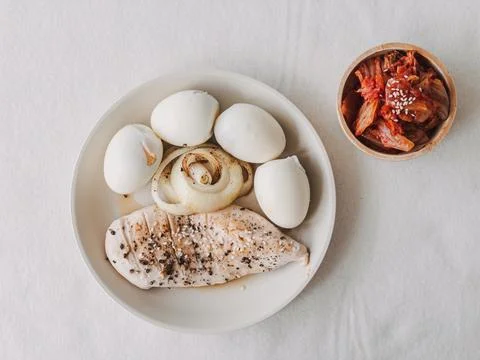 Visually appealing meal featuring perfectly cooked eggs and lean chicken Stock Photos