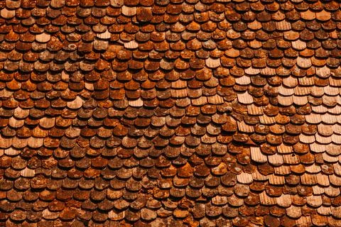 A visually appealing pattern featuring rustic wooden roof tiles, exuding charm Stock Photos