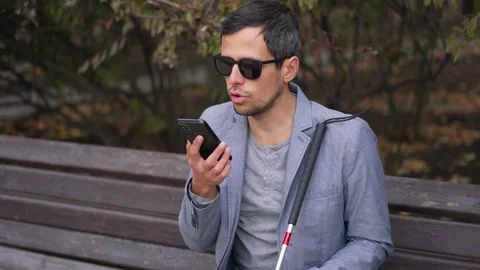 Visually Impaired Man Talking on the Phone in a Park Stock Footage 290923248