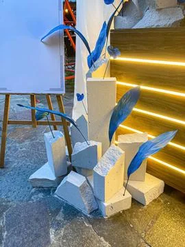 A visually striking artwork featuring three stacked, blue-adorned concrete .. Stock Photos