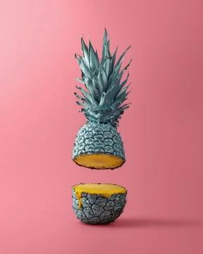 Visually striking floating pineapple with metallic peel and a drip of juice.. Stock Photos