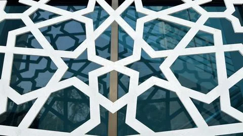 A visually striking white geometric screen overlaying reflective blue glass w Stock Photos