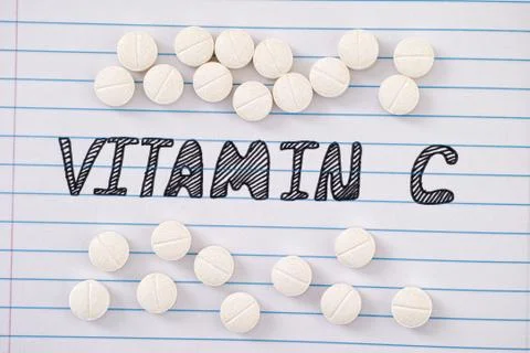 Vitamin C - ascorbic acid on notebook sheet Photos