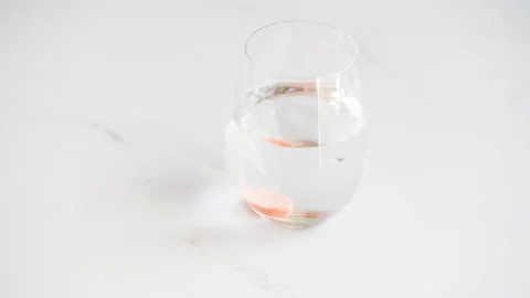 Vitamin C effervescent tablet dissolving in a glass of water Stock Footage 132507137