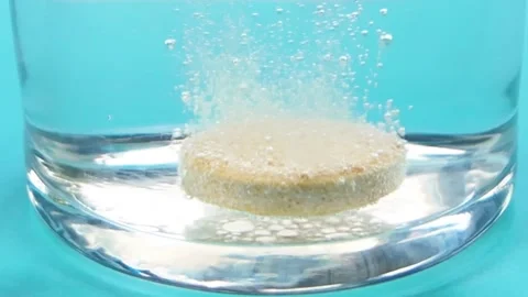 Vitamin C Effervescent Tablet Dissolving in Water Close Up Stock-Footage 344762931