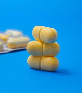 Vitamin C pills on blue background,Ascorbic Acid Tablets Stock Photos