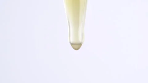 Vitamin C serum texture with dropper. Drops of yellow essential oil fall fr.. Stock Footage 269328514