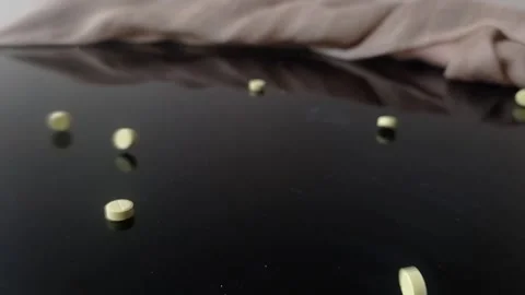 Vitamin c tablet on a black table Stock Footage 146255750