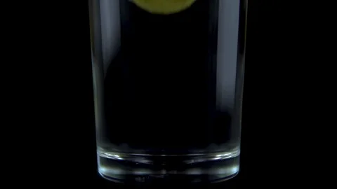 A vitamin C tablet is thrown into a transparent glass glass with water. The Stock Footage 117313247