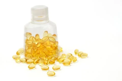 Vitamin capsules with  e poured out of bottle Stock Photos