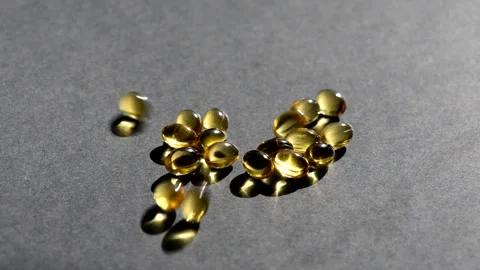 Vitamin D capsules. black background. Biologically active additives Stock Footage 149402133
