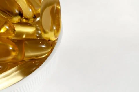 Vitamin D capsules on a light background. Stock Photos