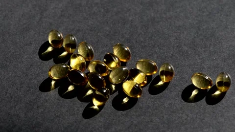 Vitamin D capsules, view around. black background. Biologically active additives Stock Footage 149182391