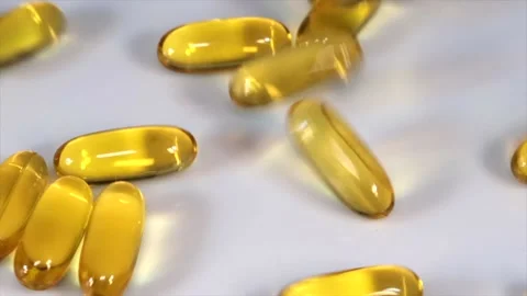 Vitamin E Capsules Falling On White Background	 Stock Footage 220787763