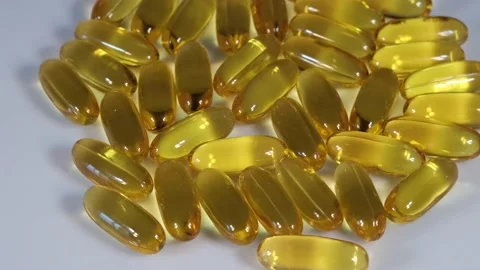 Vitamin E Capsules Rotating On White Background Stock Footage 220787842