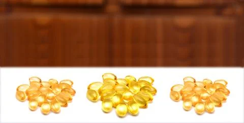 Vitamin E supplements on white background Foto stock