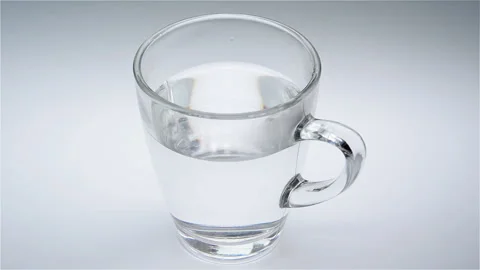 Vitamine pill dissolves on water Stock Footage 94329440