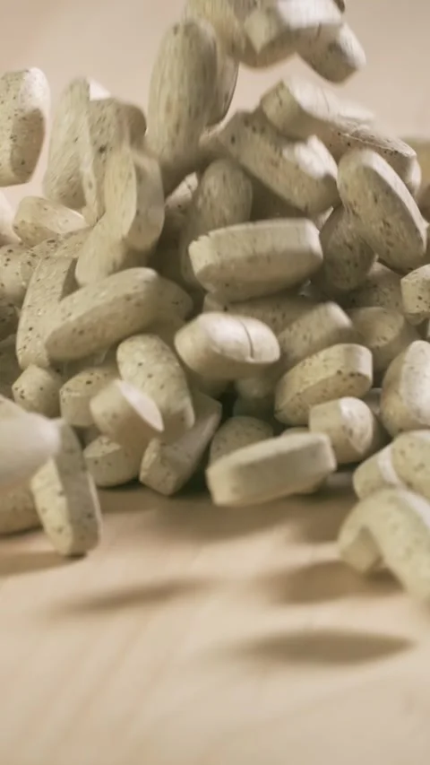 Vitamins and supplements fall in slow motion. Vertical Video. Video stock 311606661