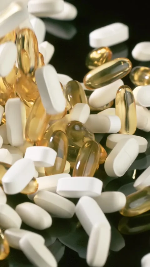 Vitamins and supplements fall in slow motion. Vertical Video. 스톡 동영상 311814093