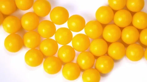 Vitamins close-up. round yellow granules vitamin rotate close-up Stock Footage 166529080