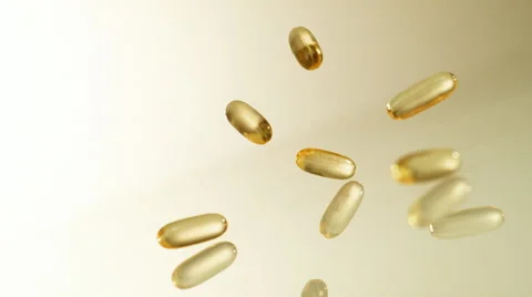 Vitamins falling on reflective surface. Slow Motion. Stock Footage 50512152