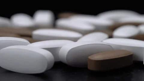 Vitamins in the form of pills on a black background. Видео 149479324