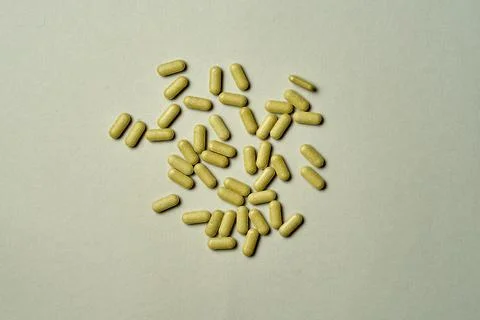 Vitamins in the form of tablets with soft light on a green background. Streng Stock Photos