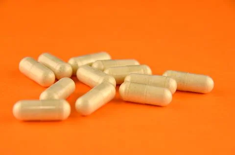 Vitamins on an orange background Stock Photos