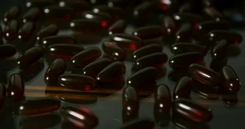 Vitamins On Reflective Surface in a studio shot Stock Footage 243665182