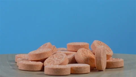 Vitamins in tablets with an orange pattern rotates Stock Footage 145764141