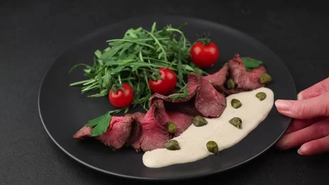 Vitello Tonnato with arugula, cherry tomatoes, capers, and parsley. Stock Footage 329622869